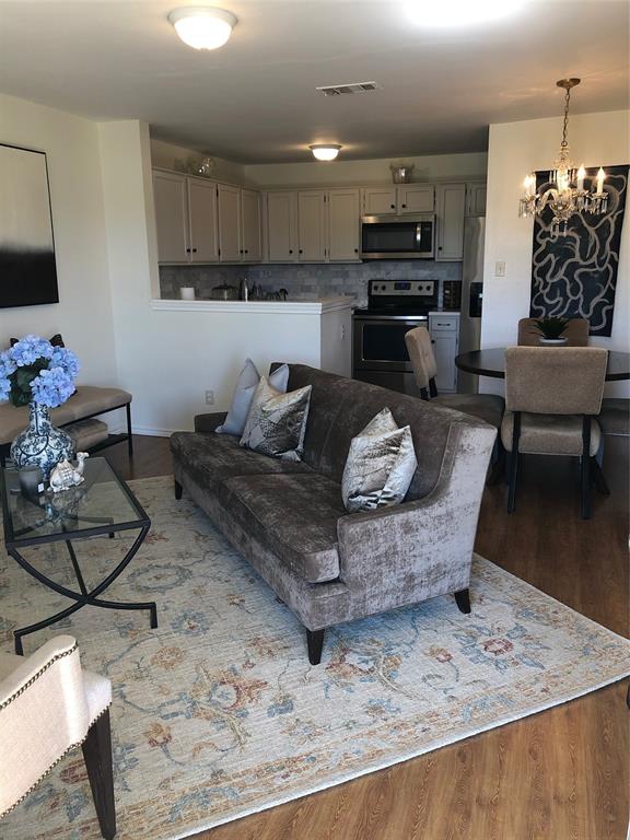6108 Abrams Road, Unit 613 Dallas, TX 75231 - Photo 9 of 27 a living room with furniture and kitchen view