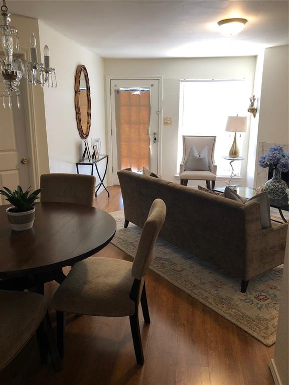 6108 Abrams Road, Unit 613 Dallas, TX 75231 - Photo 10 of 27 a dining room with furniture and wooden floor