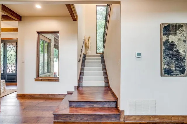 a spacious bedroom with a bed and a chandelier