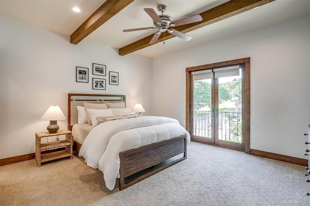 9930 Boat Club Road Fort Worth, TX 76179 - Photo 23 of 40 a spacious bedroom with a bed and a chandelier