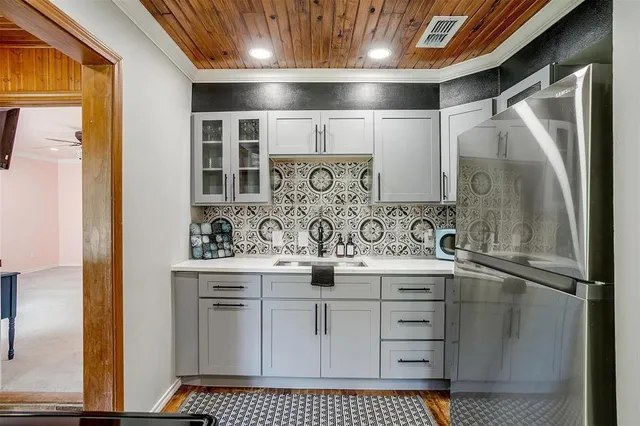 a front view of a house with a yard potted plants and a fountain