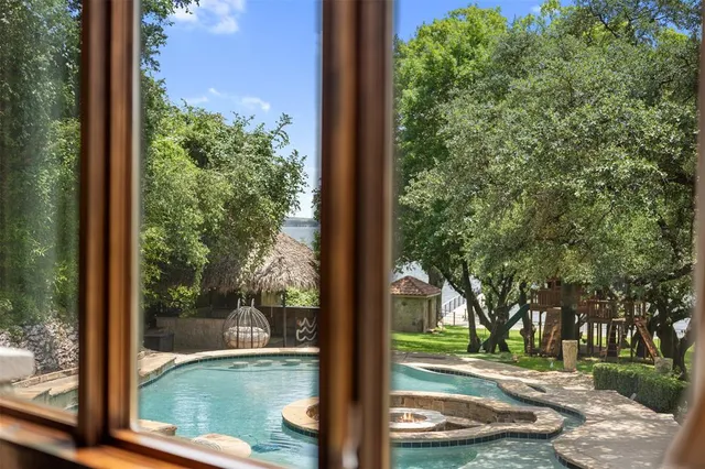 a front view of a house with a yard and potted plants