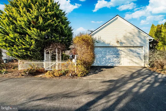 an aerial view of a house with car parked