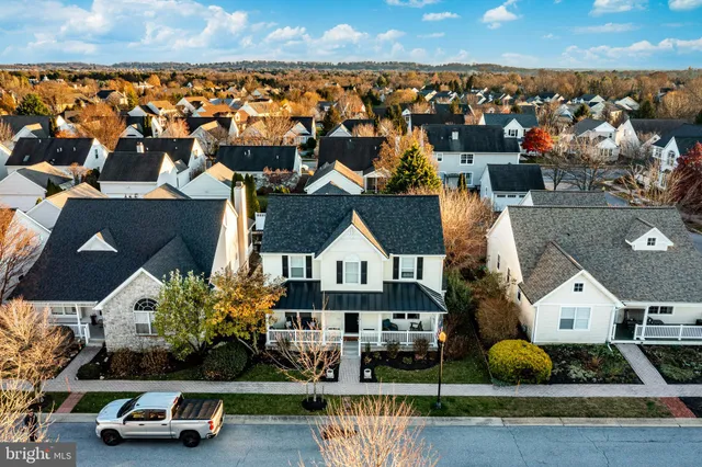 an aerial view of multiple houses with yard