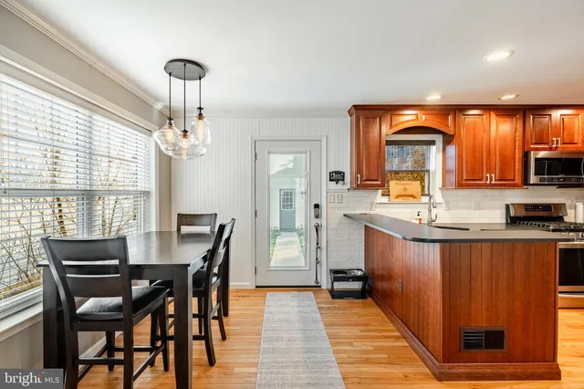 a kitchen with stainless steel appliances granite countertop sink stove top oven and cabinets