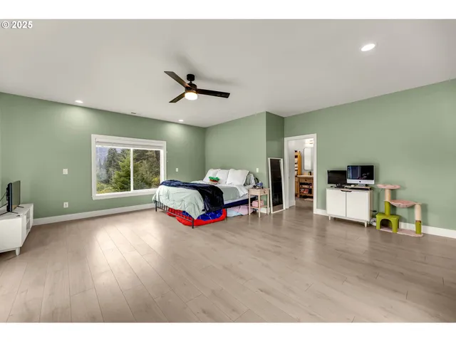 a bedroom with furniture and large window