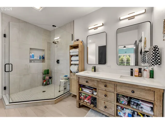 a bathroom with a sink a vanity a mirror and a shower