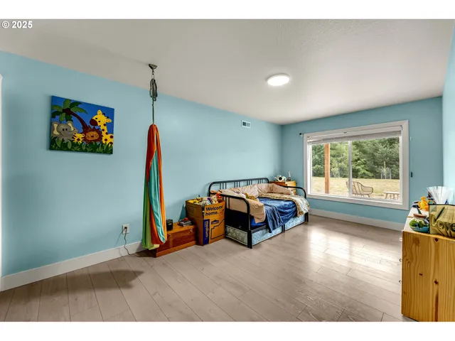 a bedroom with furniture and a flat screen tv