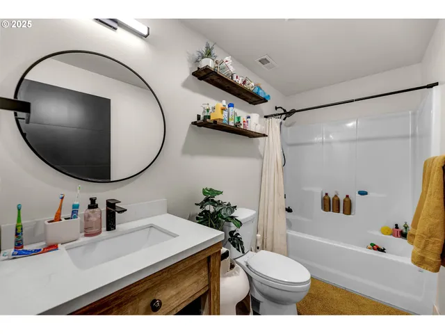 a bathroom with a sink a toilet and a mirror