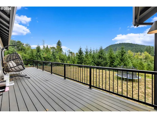 a view of balcony with wooden floor and outdoor seating