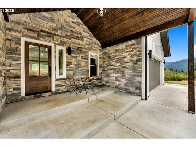 a view of a patio with table and chairs and potted plants