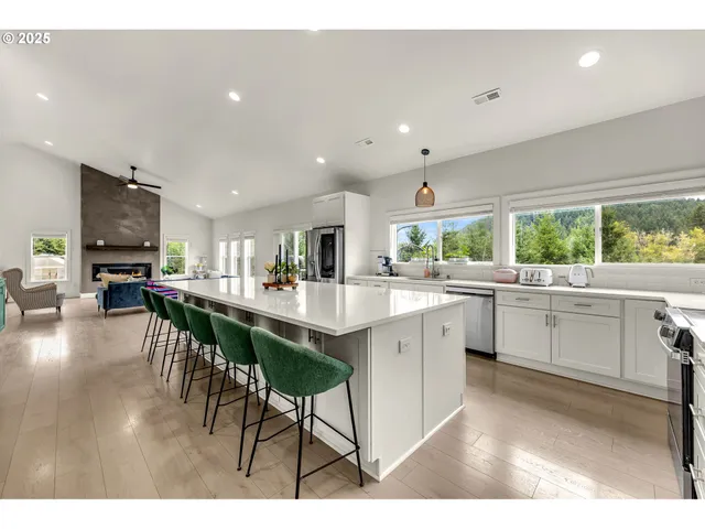 a kitchen with a table chairs sink and cabinets