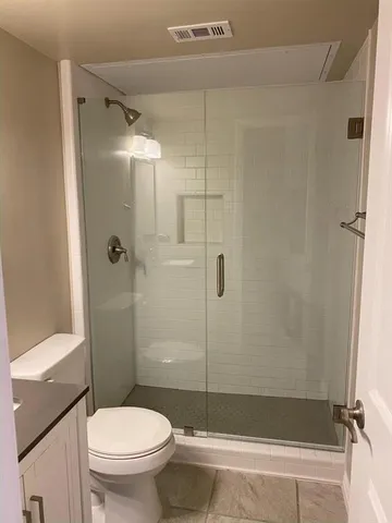 a bathroom with a shower and a toilet