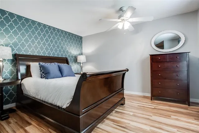 a bedroom with a bed and a ceiling fan