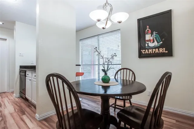 a view of a dining room with furniture wooden floor and chandelier