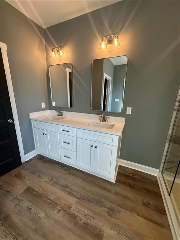 5207 Lee Road Salem, AL 36874 - Photo 9 of 23 Full bathroom featuring double vanity, dark wood-style flooring, and a walk in shower