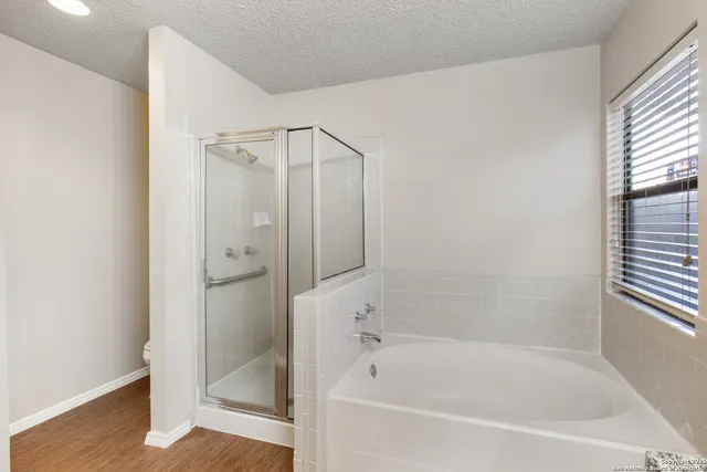 a white bath tub sitting next to a shower