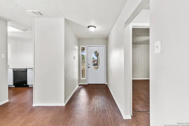 a view of hallway with wooden floor