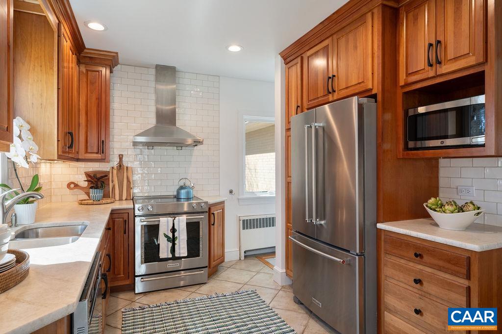 15 Orchard Road Charlottesville, VA 22903 - Photo 18 of 38 a kitchen with stainless steel appliances granite countertop a refrigerator a stove and a sink with wooden cabinets