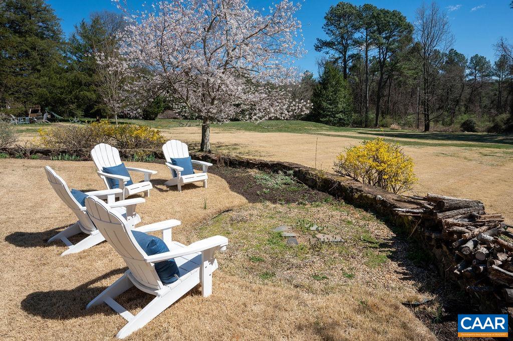 15 Orchard Road Charlottesville, VA 22903 - Photo 4 of 38 a view of a backyard with table and chairs under an umbrella