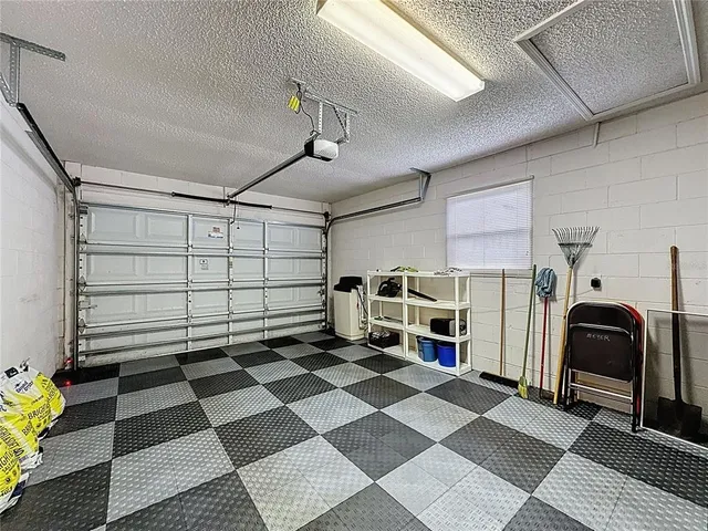 a room with lots of tables a large window and chairs