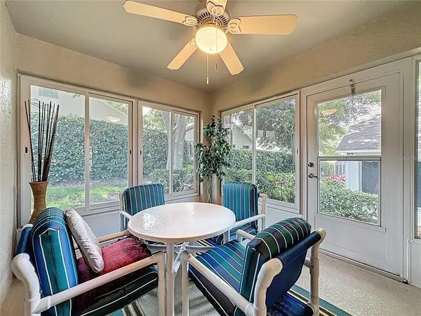 a tennis court with view of trees in the background