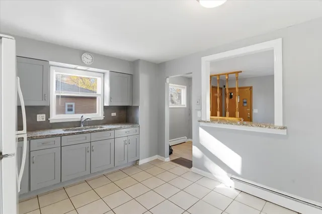 a kitchen with a refrigerator and a stove top oven