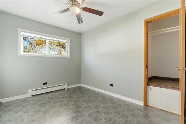 an empty room with closet and window