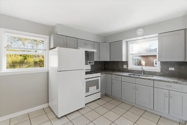 a spacious bathroom with a mirror a sink and a window