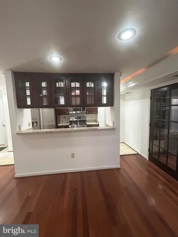 a view of kitchen with refrigerator and window