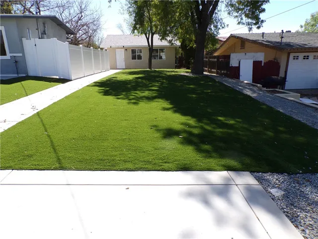 a view of house with backyard