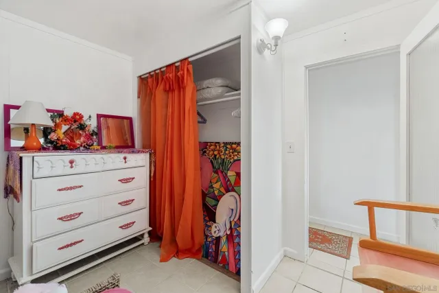 a view of walk in closet with clothes