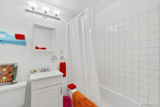 a bathroom with a sink and a shower curtain