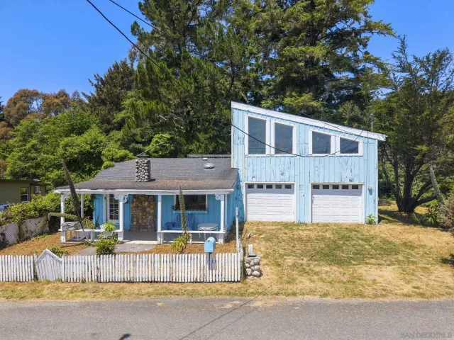 a front view of a house with a garden and porch