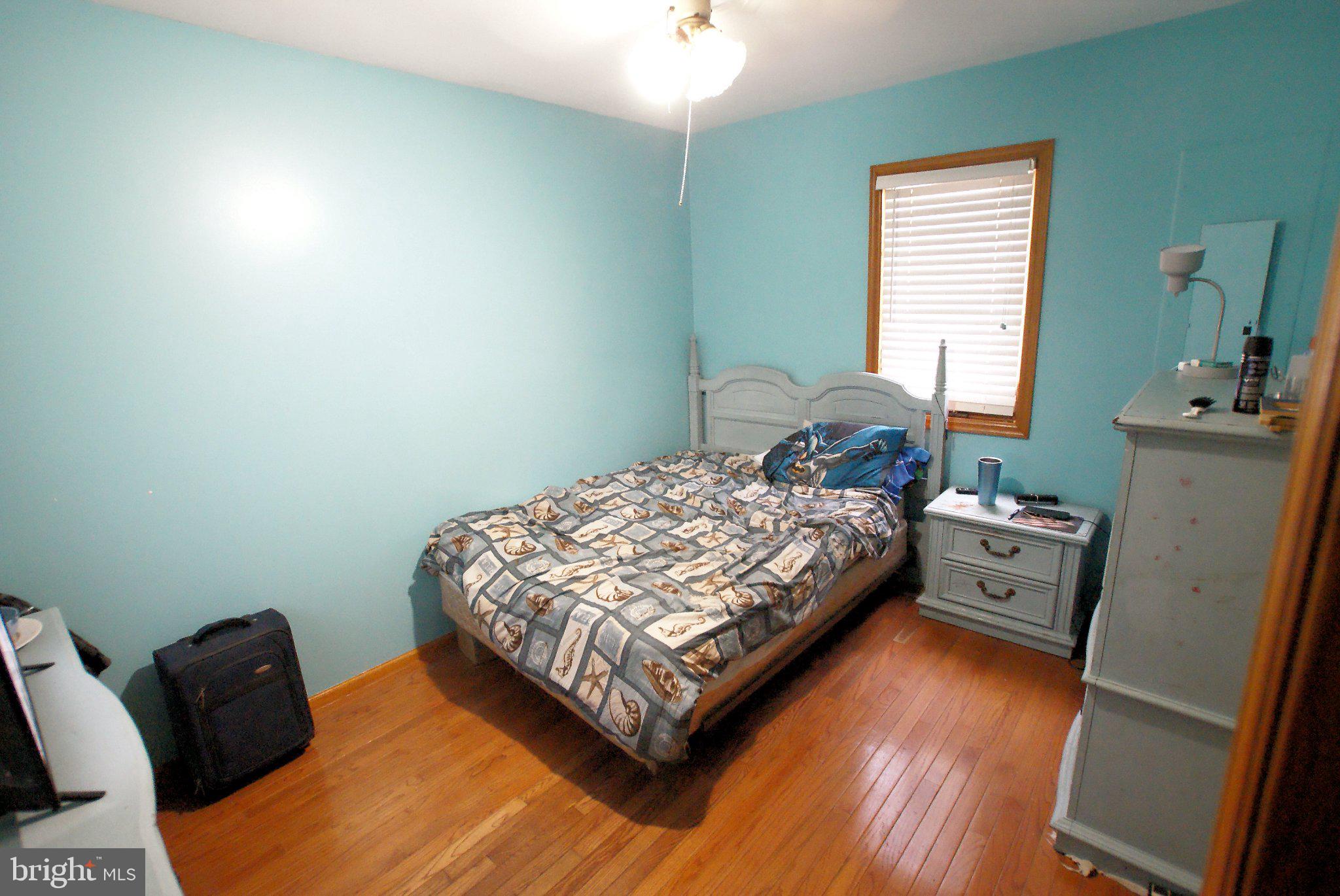 387 Frog Pond Road Little Egg Harbor, NJ 08087 - Photo 11 of 23 a bedroom with a bed and wooden floor