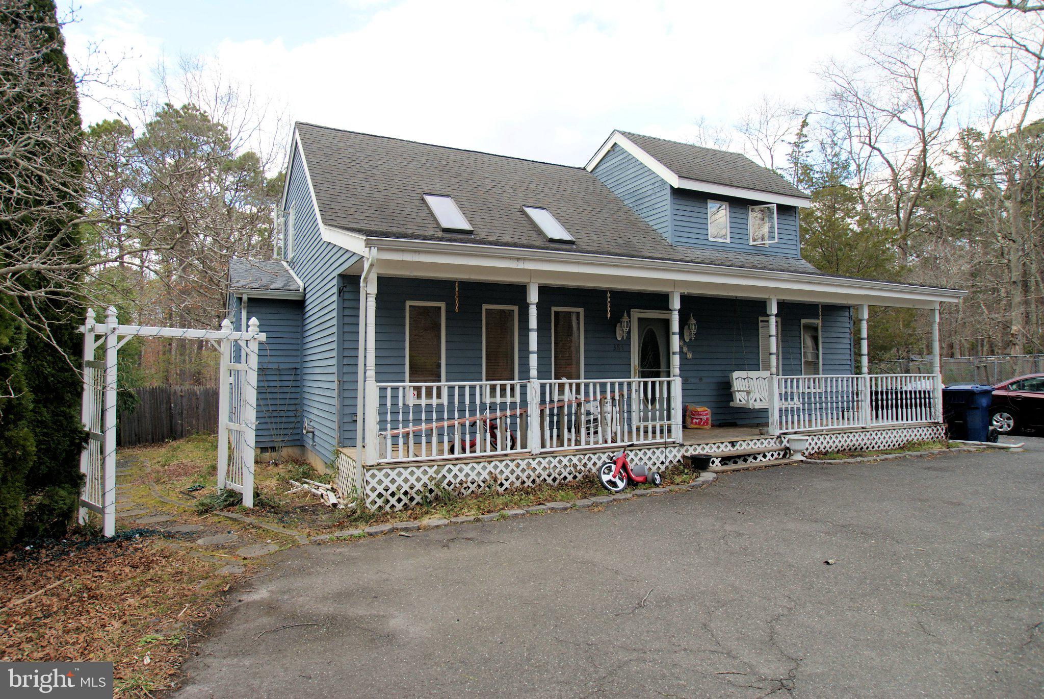 387 Frog Pond Road Little Egg Harbor, NJ 08087 - Photo 2 of 23 front view of a house with a small yard and a large tree