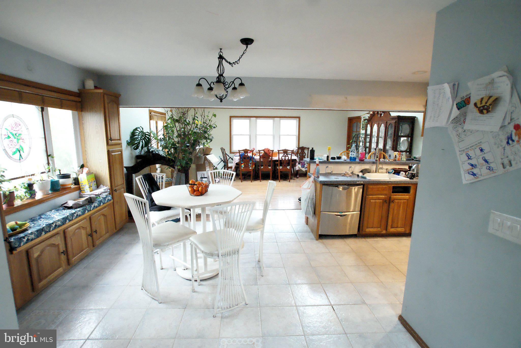 387 Frog Pond Road Little Egg Harbor, NJ 08087 - Photo 5 of 23 a kitchen with stainless steel appliances a table and chairs in it