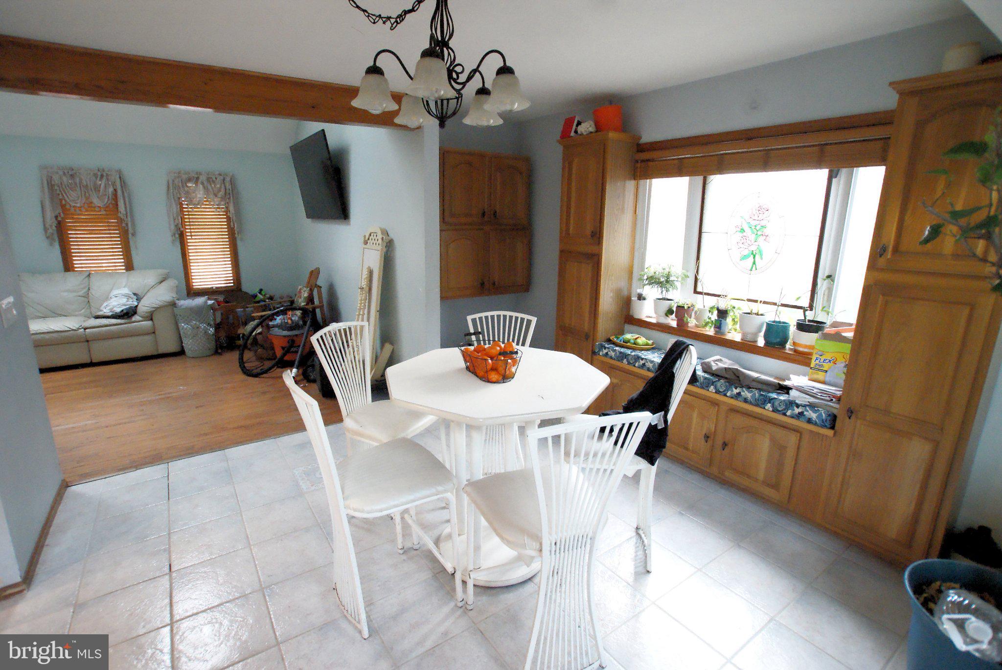 387 Frog Pond Road Little Egg Harbor, NJ 08087 - Photo 6 of 23 a dining room with wooden floor a chandelier a wooden table and chairs