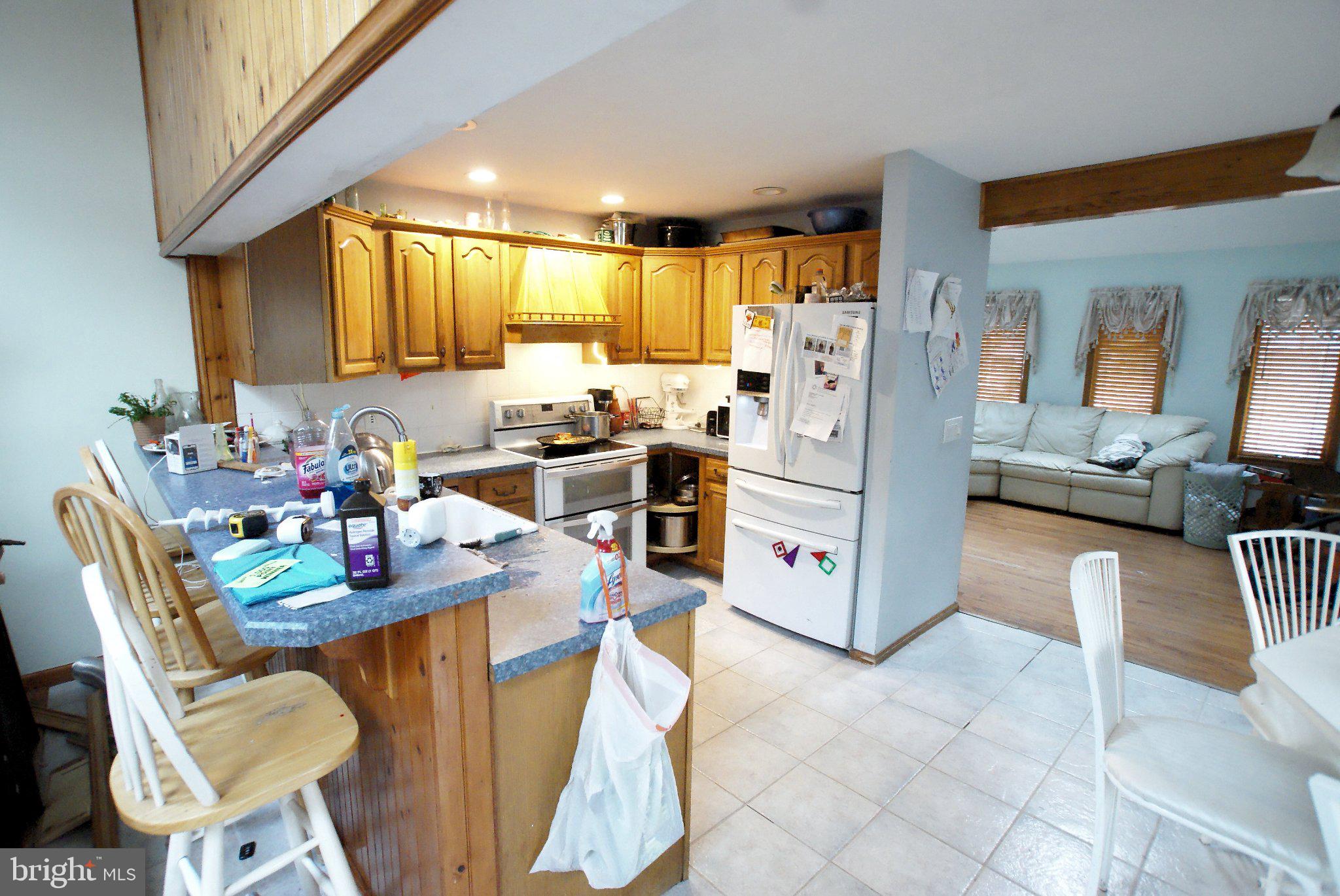 387 Frog Pond Road Little Egg Harbor, NJ 08087 - Photo 7 of 23 a kitchen with stainless steel appliances kitchen island granite countertop a refrigerator a stove a sink dishwasher and white cabinets with wooden floor