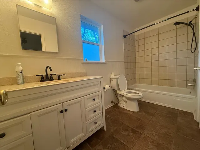 a bathroom with a sink a toilet and bathtub