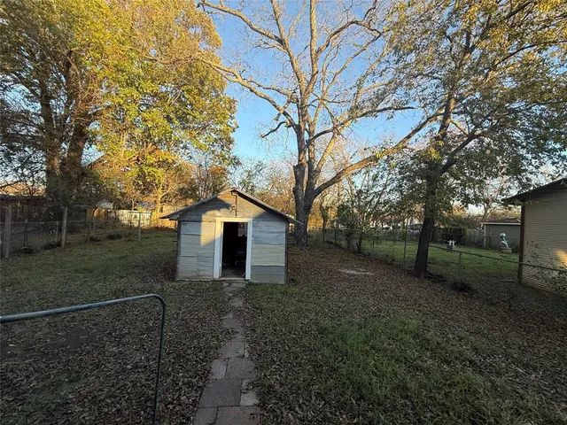a white house that has a tree in front of it