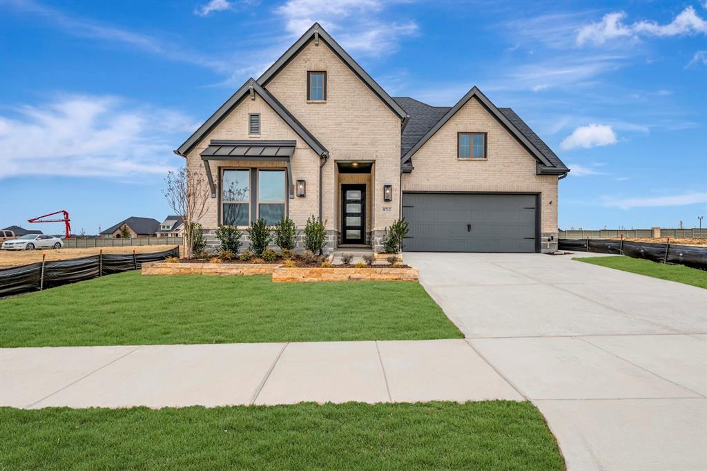 8712 Chestnut Lane Justin, TX 76247 - Photo 1 of 29 View of front of home with brick siding, concrete driveway, and a standing seam roof