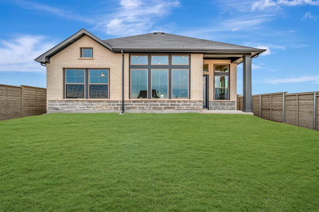 8712 Chestnut Lane Justin, TX 76247 - Photo 2 of 29 Rear view of house featuring a fenced backyard, a patio area, brick siding, and roof with shingles