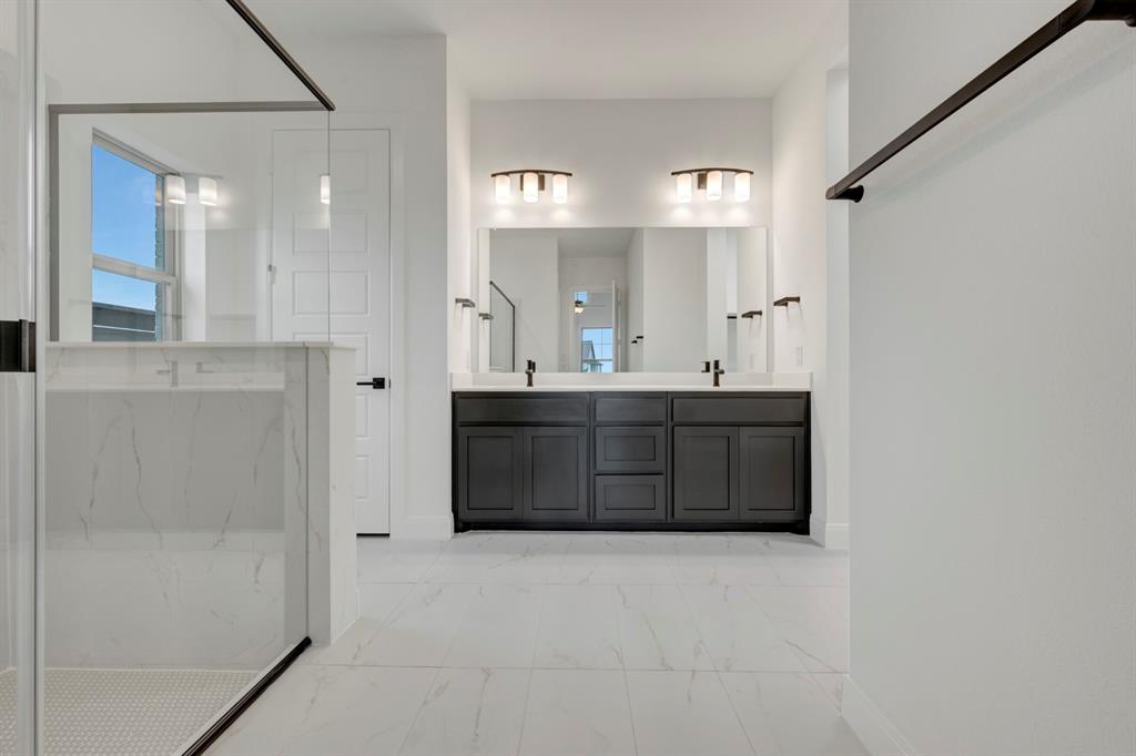 8712 Chestnut Lane Justin, TX 76247 - Photo 22 of 29 Bathroom featuring double vanity, light marble finish floors, and a marble finish shower