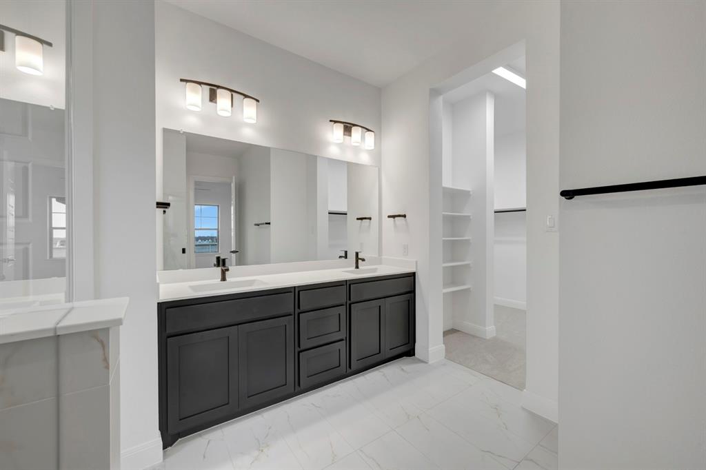 8712 Chestnut Lane Justin, TX 76247 - Photo 23 of 29 Bathroom with double vanity, a spacious closet, and light marble finish floors