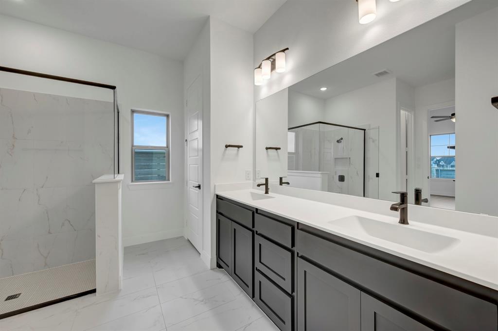 8712 Chestnut Lane Justin, TX 76247 - Photo 24 of 29 Bathroom with double vanity, a marble finish shower, light marble finish floors, and recessed lighting