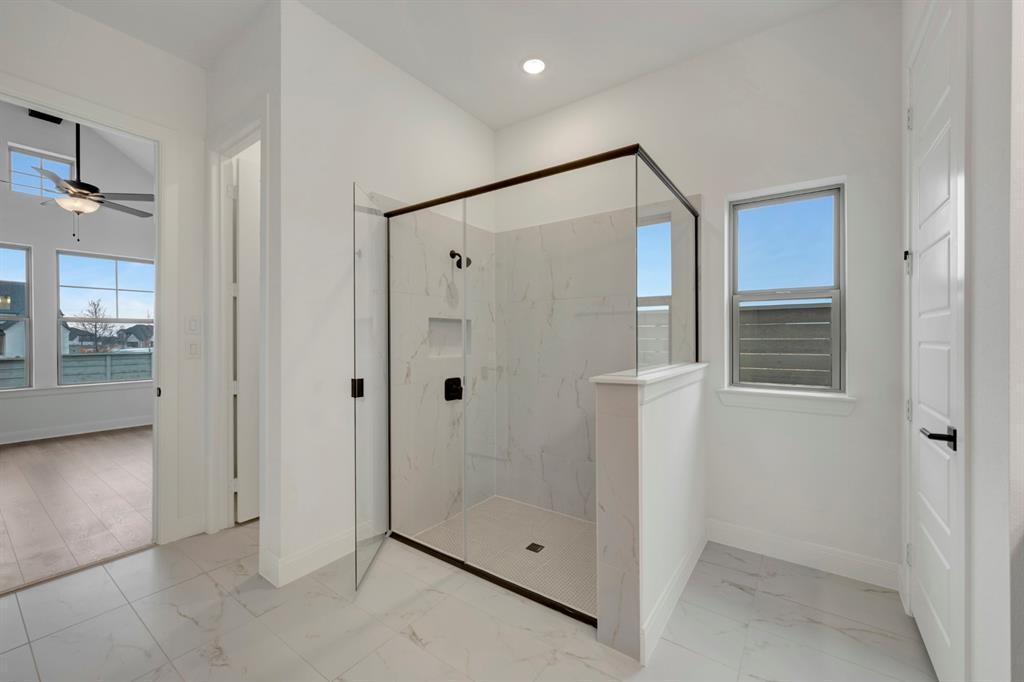 8712 Chestnut Lane Justin, TX 76247 - Photo 25 of 29 Bathroom featuring a marble finish shower, light marble finish flooring, a ceiling fan, and recessed lighting