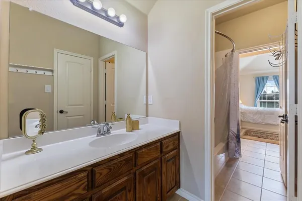a bathroom with a sink a vanity and a mirror