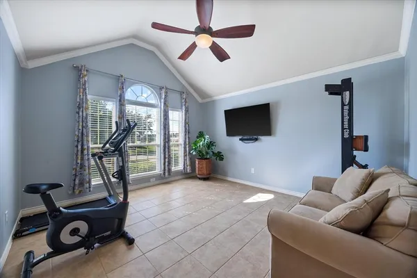 a living room with furniture a flat screen tv and a floor to ceiling window