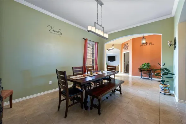 a dining room with furniture a chandelier and a rug